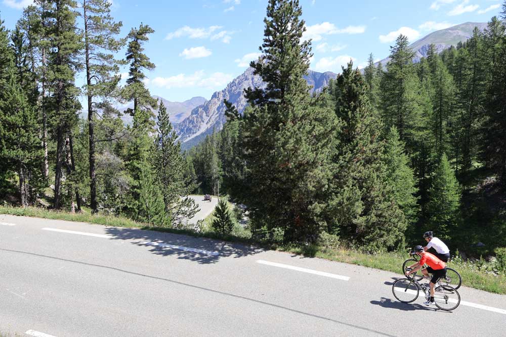 Cyclist navigating scenic mountain road.