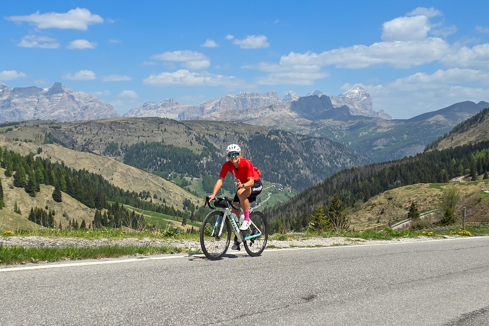 Cyclist climbing a mountain road in the Dolomites