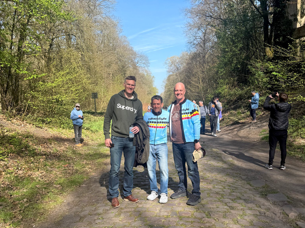Guests standing on the cobbled Forest of Arenberg sector during a Spring Classics tour.