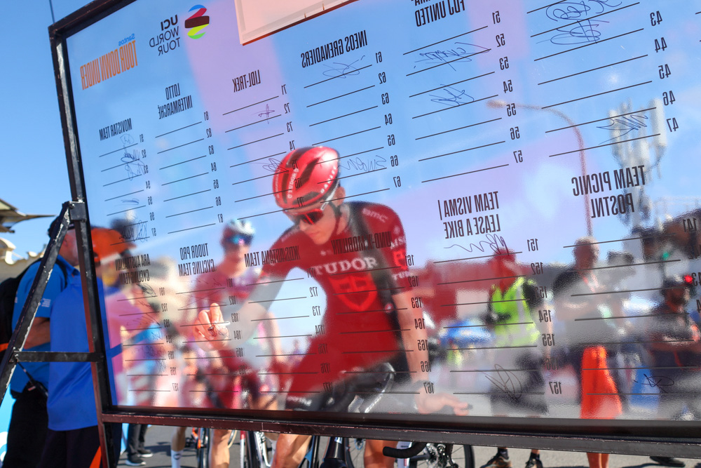 Professional cyclist reflected in the rider presentation board at the Tour Down Under