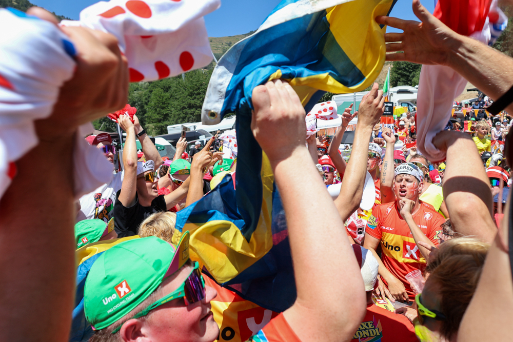 Tour de France race vehicles travelling through crowds on Alpe d'Huez