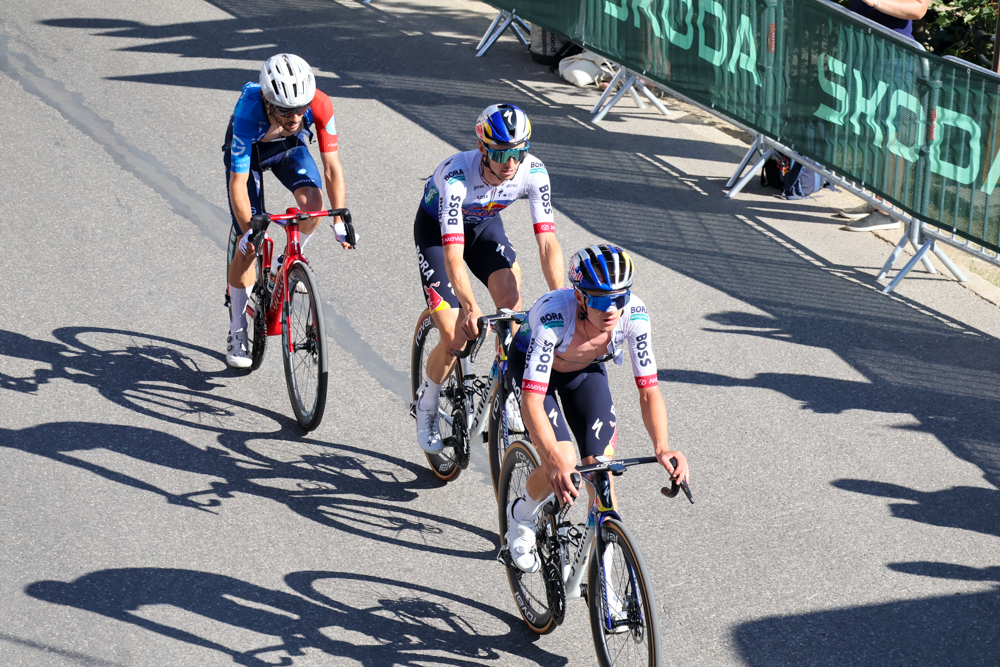 Professional cyclist climbing through the crowd on Alpe d'Huez